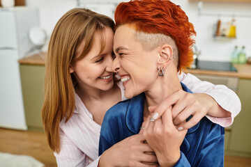 Fototapeta premium Young love blossoms in a cozy modern apartment between two beautiful women