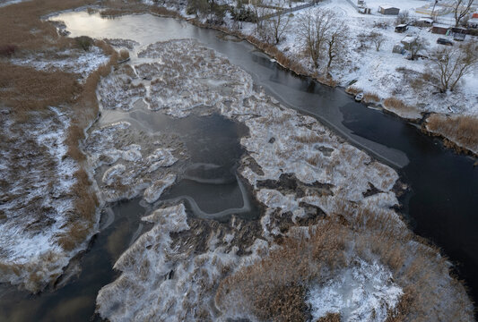 snow covered earth, ice covered river. Aerial landscape, abstract lines and shapes. - Powered by Adobe
