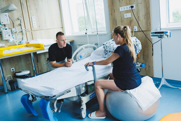 A woman and a man are expecting a baby and are in the delivery room. Partner childbirth. Support...