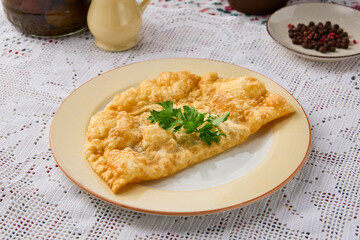 Golden Cheburek on White Plate Rustic Culinary Art with Vintage Aesthetic