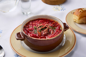 Vibrant Bowl of Beetroot Borscht with Tender Beef in Rustic Ceramic Dish on Bright Tablecloth