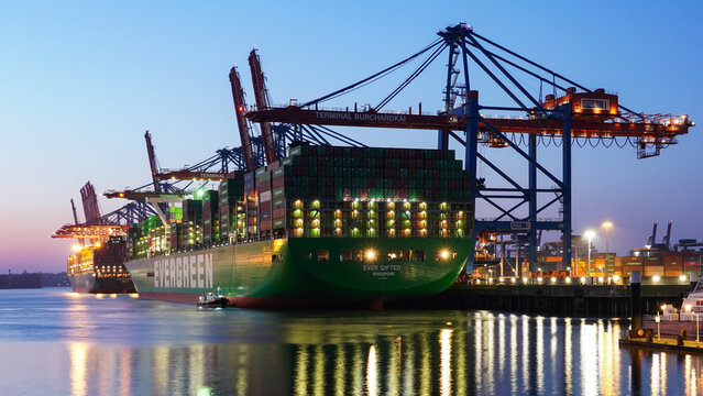 Illuminated container ship "Ever Gifted" is moored at "Burchardkai" in the Port of Hamburg at night