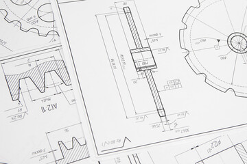 paper engineering drawings of industrial parts and mechanisms