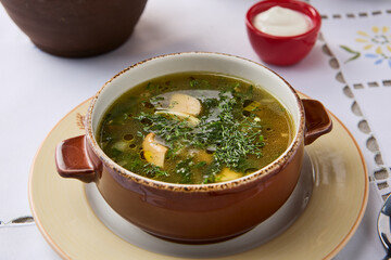 Rustic Mushroom Soup with Fresh Herbs and Cream Garnish in Cozy Setting