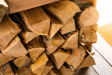 Oak firewood for heating a room close-up. Stacked cut and chopped firewood in winter