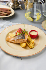 Grilled Trout Steak with Potatoes on Elegant Table Setting