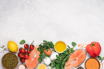 Cooking or buying healthy food background. Assortment of fresh fish with aromatic herbs, spices, vegetables and beans