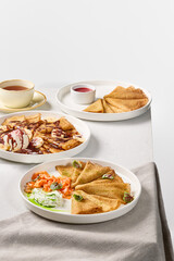 Elegant Breakfast Spread with Pancakes and Assorted Fillings on Linen Tablecloth