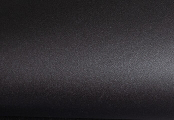 Elegant black paper background with a smooth, textured surface, monochrome design creating a...