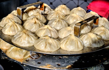 The image shows manty, a traditional dish of Central Asian cuisine, steamed to perfection