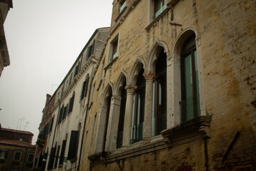 Carved Gothic windows on ancient residential house stone building of Venetian streets, Venice, Italy
