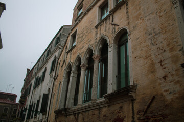 Carved Gothic windows on ancient residential house stone building of Venetian streets, Venice, Italy