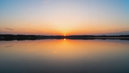 Serene sunset over tranquil lake, nature’s peaceful reflection