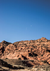 Rugged Red Rock Landscape with Distant Airplane Trail