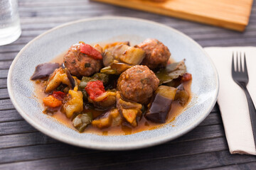 Steamed meatballs with stewed vegetables with haze on plate