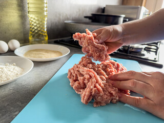 Woman hand knead fresh minced meat close-up, prepare cooking tasty cutlets