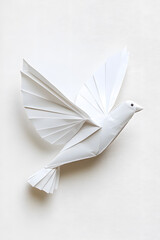 White dove bird made of white folded paper, symbolizing peace, origami bird, isolated on white background