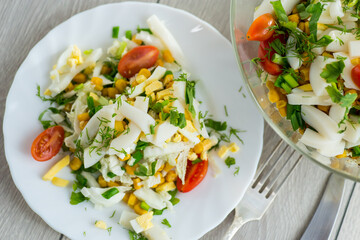 Chinese cabbage salad with squid, eggs, tomatoes and other vegetables