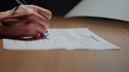 Businessman signing important contract at office desk
