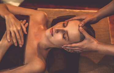 Caucasian woman enjoying relaxing anti-stress head massage and pampering facial beauty skin...