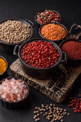Variations of spices, allspice, turmeric, paprika, salt in ceramic bowls