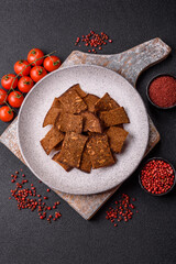 Crispy homemade brown bread chips with seeds and grains, salt, spices