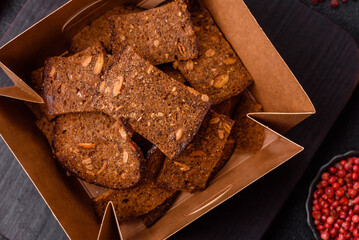 Crispy homemade brown bread chips with seeds and grains, salt, spices