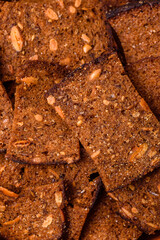 Crispy homemade brown bread chips with seeds and grains, salt, spices