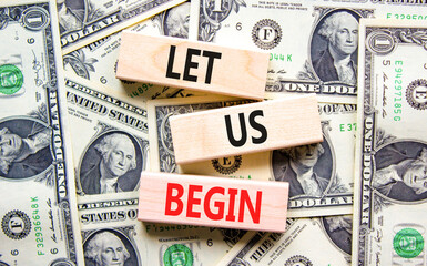 Let us begin symbol. Concept words Let us begin on beautiful wooden blocks. Dollar bills. Beautiful...