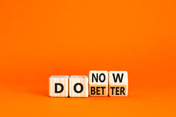 Do better and now symbol. Concept words Do better Do now on wooden block. Beautiful orange table orange background. Business do better and now concept. Copy space.