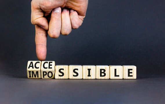 Accessible or impossible symbol. Concept words Accessible or Impossible on beautiful wooden blocks. Beautiful grey table grey background. Business accessible or impossible concept. Copy space.