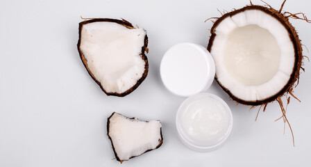 cosmetic cream and coconut on white background