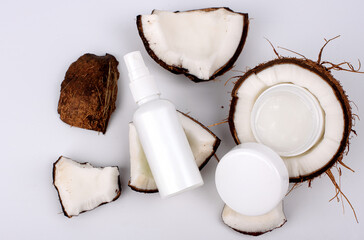 cosmetic cream and coconut on white background