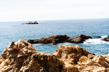 Rocky coastline and deep blue ocean at Big Sur, California.