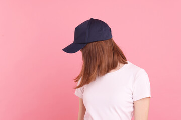 Woman in stylish baseball cap on pink background. Mockup for design