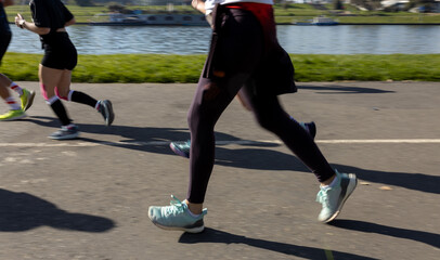 Motion blurred marathon runners in a city. Group of marathon runners compete in the race outdoors