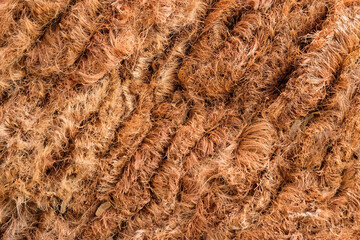 Texture background and abstract pattern of piles of brown coconut fiber brooms.Traditional handicraft industry.Copy space for text.For graphic design, banner background or 3D rendering