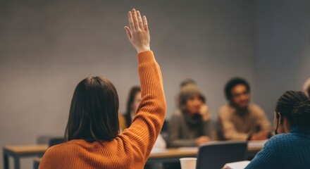 A woman in an orange sweater raises her hand in a classroom setting