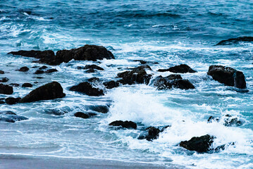 Rocky coastline and deep blue ocean at Big Sur, California.