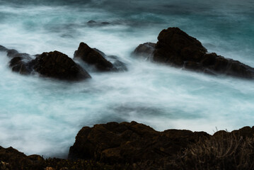 Rocky coastline and deep blue ocean at Big Sur, California.