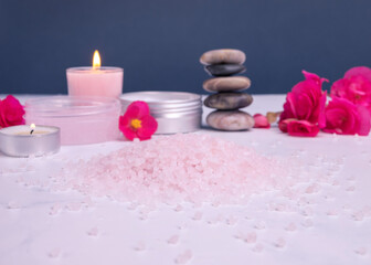 Bath salt with candles and body lotion for spa on white table