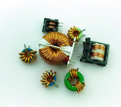 Electric small transformers of different types rotate on a white background