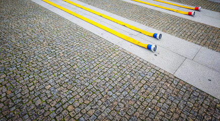 Fire hoses with valves laying on the ground. Fire fighting equipment