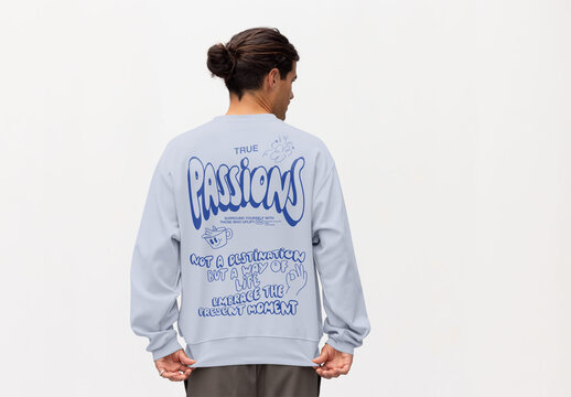 A man is standing with his back turned, ready to showcase a mockup of a jumper design in a neutral setting.