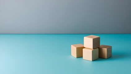 Obraz premium wooden cubes arranged on gradient gray to turquoise background for modern design concepts