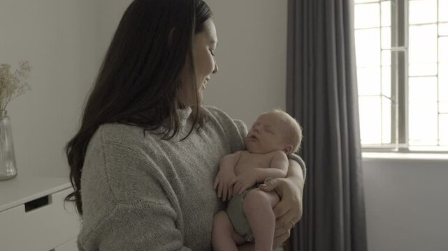 Baby, sleeping and mother with love, care and bonding or support, for tired child and home development. Hug, calm and family, young woman or mom rock her newborn kid to sleep on maternity leave