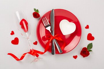 Table setting for Valentine's Day on color background, top view