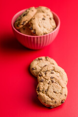 Chocolate chip cookies on red background.