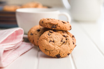 Chocolate chip cookies on white table.