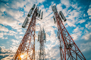 Telecommunication towers against dramatic sky, showcasing cellular technology and connectivity. scene captures essence of modern communication infrastructure